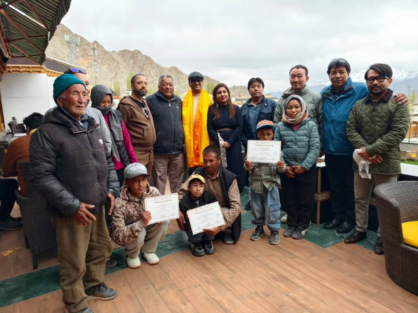 Children in Ladakh who lost their fathers in road accidents, supported by O J Agrawal Charitable Trust, with their families during the April 2026 visit by Dr. Ravi Agrawal and members of the Trust